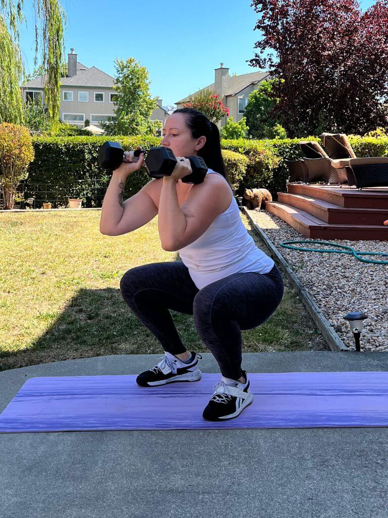 Woman doing dumbbell front squat