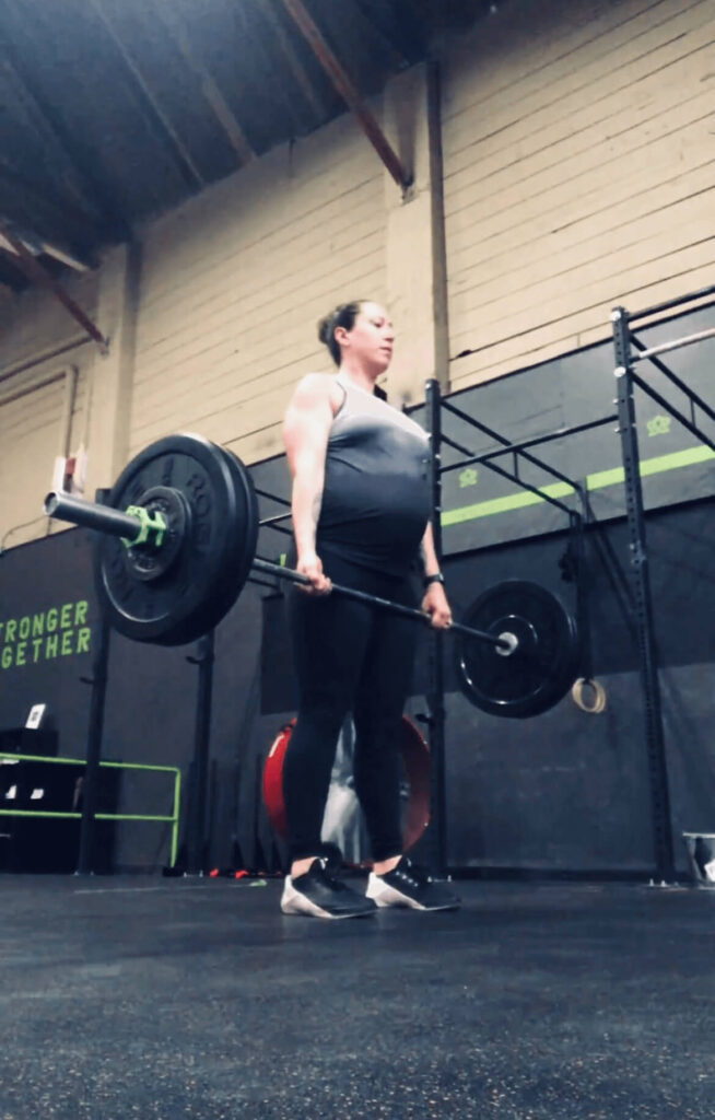 woman doing deadlifts while pregnant